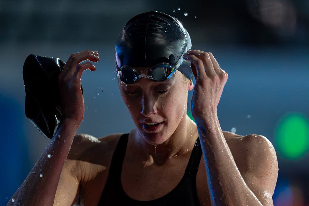Taylor Ruck adjusting her goggles on the pool deck